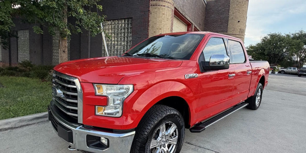 A red Ford F-150 parked in front of the dealership’s brick building on North Loudoun Street
